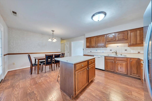2420 Carlsbad Cir, Roanoke, VA 24012 - kitchen featuring white dishwasher, a sink, light wood-style flooring, and light countertops