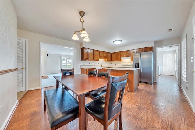 2420 Carlsbad Cir, Roanoke, VA 24012 - dining space featuring light wood finished floors, baseboards, and a chandelier