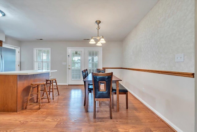 2420 Carlsbad Cir, Roanoke, VA 24012 - dining space featuring a chandelier, wood finished floors, and baseboards