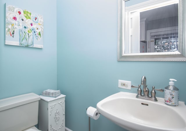 half bathroom featuring a sink and toilet