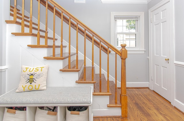 staircase with wood finished floors and baseboards
