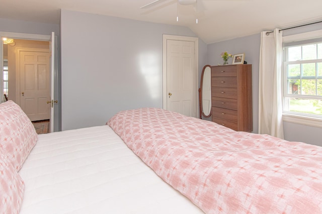 bedroom with vaulted ceiling and a ceiling fan