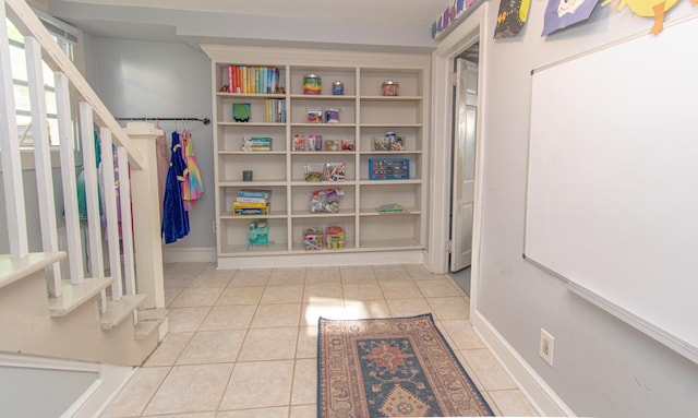 playroom with tile patterned floors and baseboards