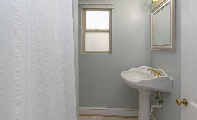 bathroom featuring tile patterned floors and baseboards