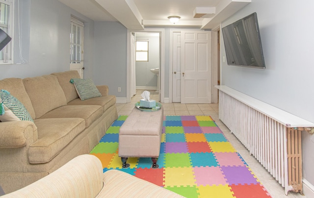 living room with baseboards and light tile patterned flooring