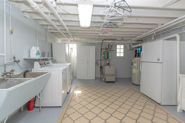 laundry room featuring water heater, washer and clothes dryer, and a heating unit