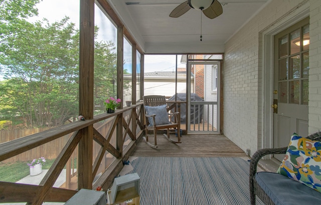 sunroom / solarium featuring ceiling fan