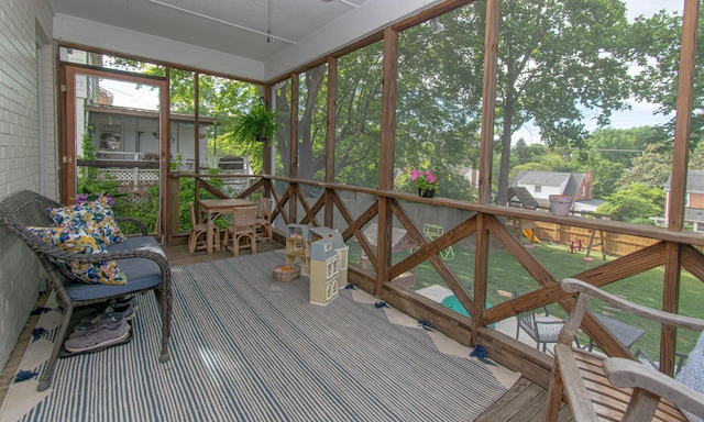 sunroom featuring ceiling fan and healthy amount of natural light