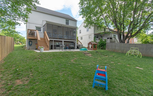 rear view of house featuring a sunroom, a patio, and stairs