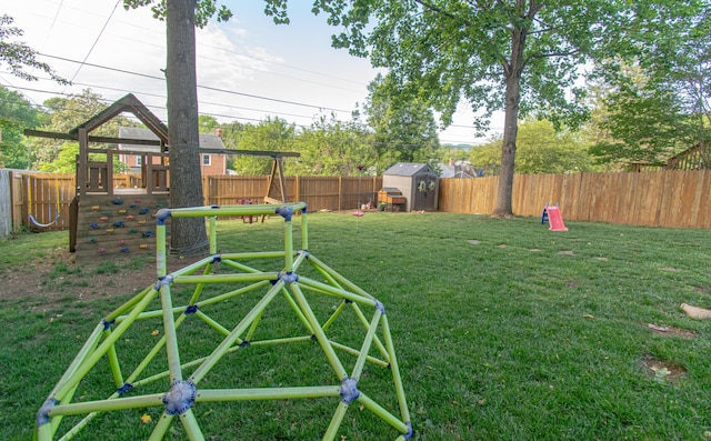 view of yard with a playground, a shed, and an outdoor structure
