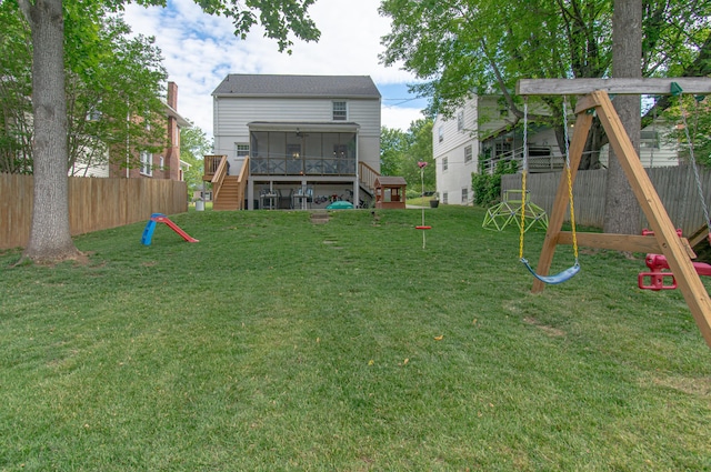 view of yard with a sunroom and stairs