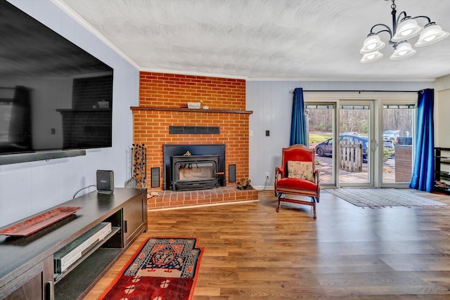 3553 Kidder Ln, Salem, VA 24153 - living room featuring ornamental molding, a wood stove, a chandelier, and wood finished floors