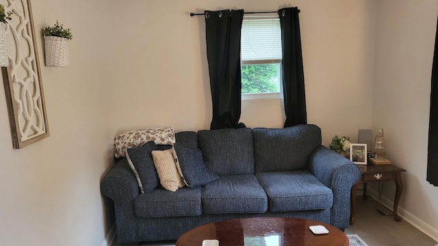 living area featuring baseboards