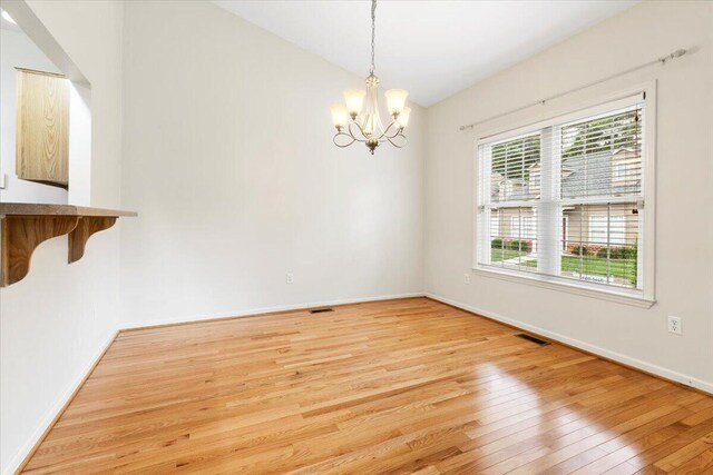 6618 Hartman Ct, Roanoke, VA 24019 - unfurnished dining area featuring light wood-style floors, a chandelier, baseboards, and lofted ceiling