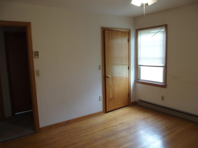 107 Lilac Dr, Shawsville, VA 24162 - empty room featuring plenty of natural light, light wood-type flooring, a baseboard radiator, and baseboards