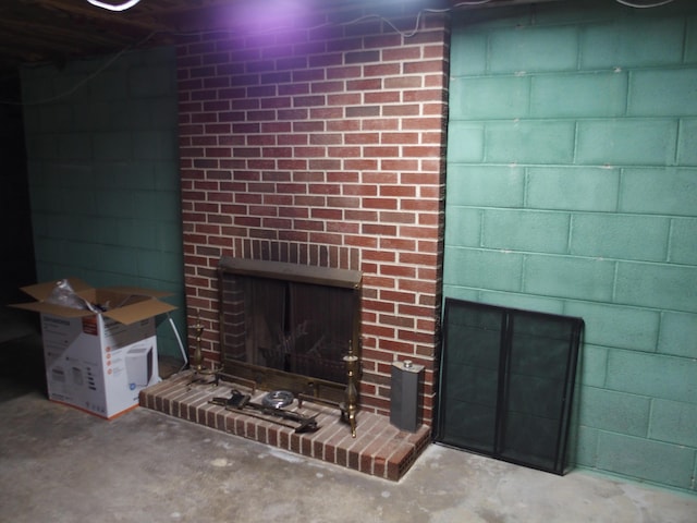 107 Lilac Dr, Shawsville, VA 24162 - detailed view of a brick fireplace, concrete flooring, and concrete block wall