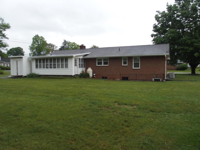 107 Lilac Dr, Shawsville, VA 24162 - back of house featuring a yard, brick siding, and a chimney