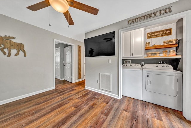 60 Surber Dr, Moneta, VA 24121 - clothes washing area with cabinet space, washing machine and dryer, ceiling fan, and wood finished floors