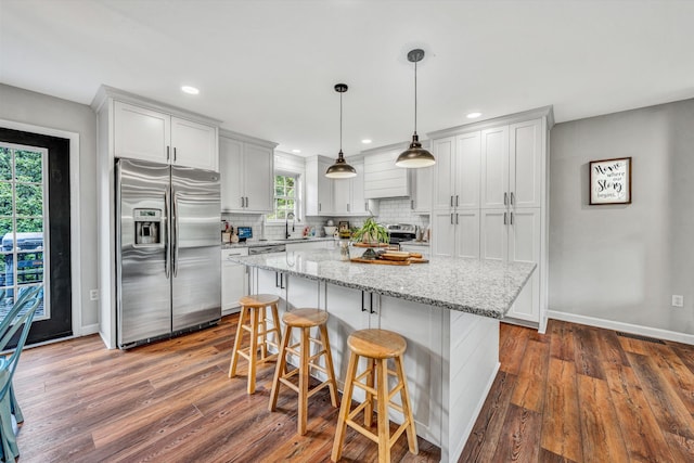 60 Surber Dr, Moneta, VA 24121 - kitchen with stainless steel appliances, tasteful backsplash, dark wood-style flooring, a kitchen bar, and recessed lighting