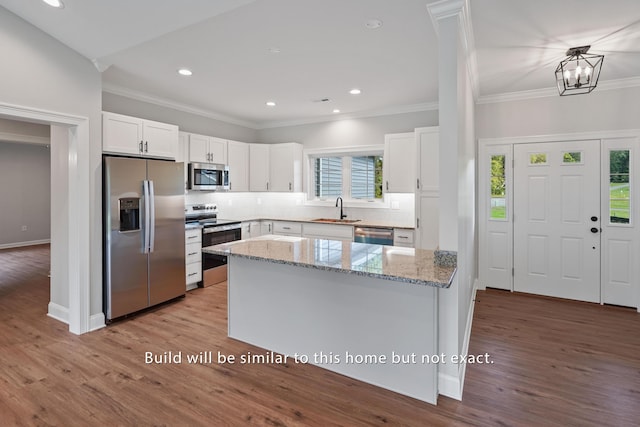 81 Belvior Cir, Moneta, VA 24121 - kitchen featuring stainless steel appliances, crown molding, white cabinetry, a sink, and light stone counters