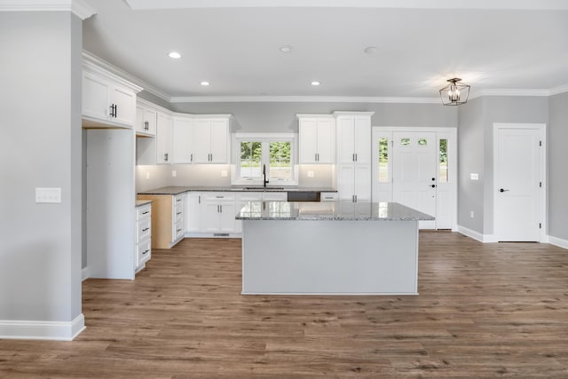 105 Belvior Cir, Moneta, VA 24121 - kitchen with a center island, white cabinets, wood finished floors, ornamental molding, and light stone counters