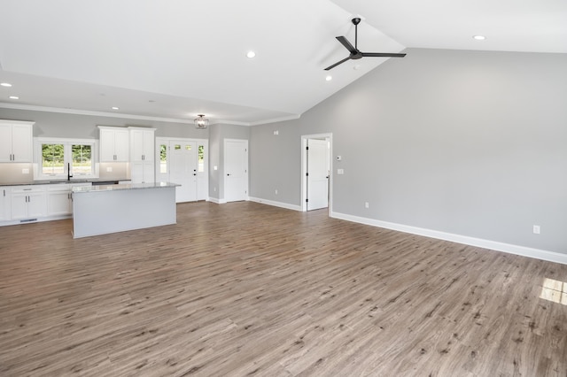 105 Belvior Cir, Moneta, VA 24121 - unfurnished living room with recessed lighting, ceiling fan, wood finished floors, high vaulted ceiling, and ornamental molding