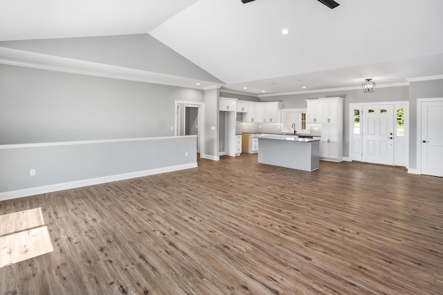 105 Belvior Cir, Moneta, VA 24121 - unfurnished living room featuring ceiling fan, vaulted ceiling, dark wood-style floors, crown molding, and recessed lighting