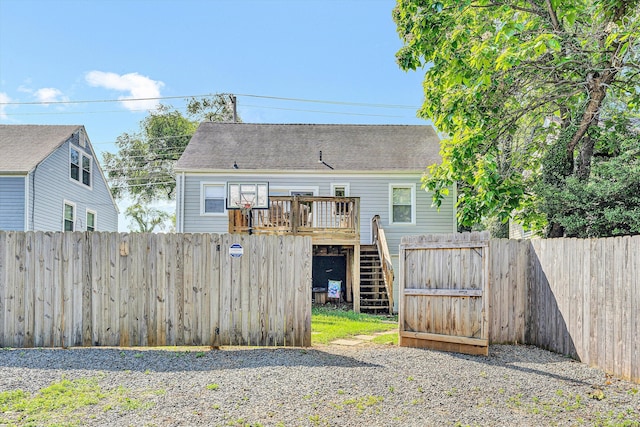 2515 Colonial Ave SW, Roanoke, VA 24015 - back of house featuring a fenced backyard, a wooden deck, stairs, and a shingled roof