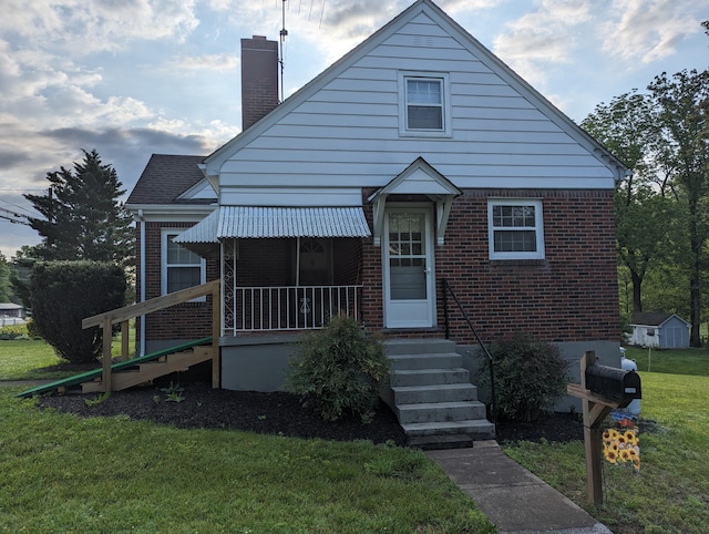1987 Franklin St, Rocky Mount, VA 24151 - bungalow-style house featuring a front lawn, a chimney, brick siding, and a storage shed