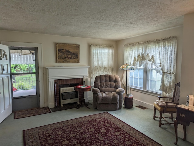 1987 Franklin St, Rocky Mount, VA 24151 - living room featuring a fireplace, plenty of natural light, a textured ceiling, baseboards, and heating unit