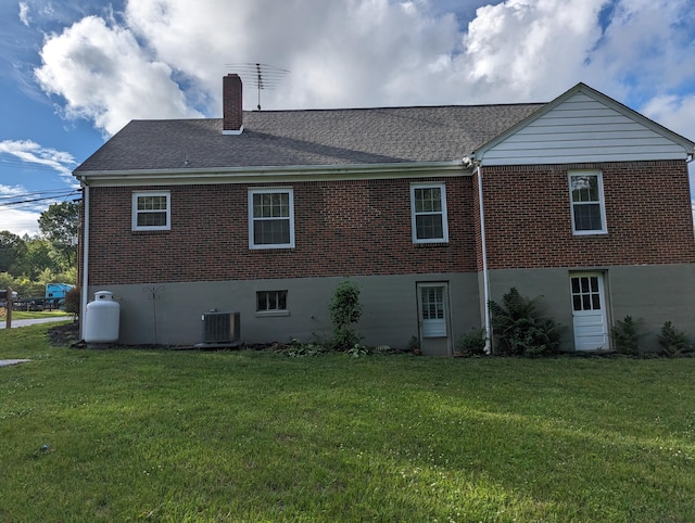 1987 Franklin St, Rocky Mount, VA 24151 - rear view of house with brick siding, a chimney, a yard, and a shingled roof