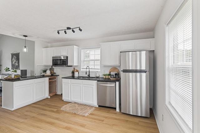 1503 Cassell Ln, Bedford, VA 24523 - kitchen featuring stainless steel appliances, a sink, dark countertops, white cabinetry, and light wood-style flooring
