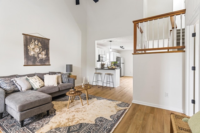1503 Cassell Ln, Bedford, VA 24523 - living area with light wood finished floors, a ceiling fan, baseboards, and a towering ceiling