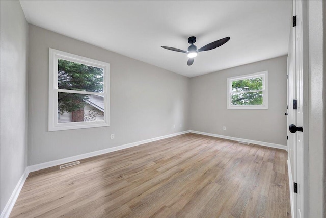 unfurnished room with light wood finished floors, ceiling fan, and baseboards