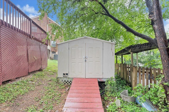 view of shed featuring fence
