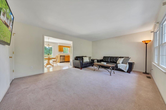 112 N Rome Dr, Roanoke, VA 24019 - living room featuring light colored carpet, a chandelier, and baseboards