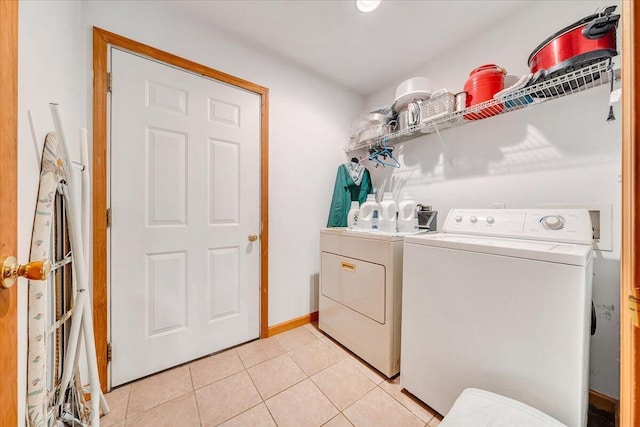 338 White Oak Ln, New Castle, VA 24127 - washroom featuring washing machine and dryer, light tile patterned floors, and baseboards
