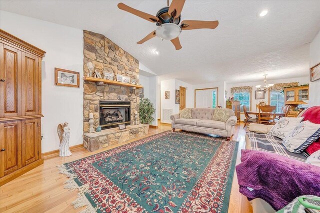 338 White Oak Ln, New Castle, VA 24127 - living area featuring ceiling fan, a fireplace, light wood-style floors, baseboards, and a chandelier