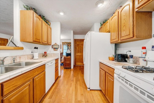 338 White Oak Ln, New Castle, VA 24127 - kitchen featuring white appliances, light wood-type flooring, tile counters, and a sink