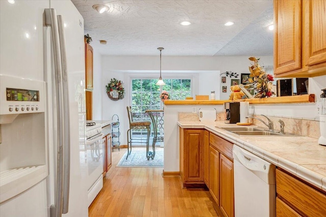 338 White Oak Ln, New Castle, VA 24127 - kitchen featuring white appliances, light wood finished floors, a peninsula, a sink, and baseboards