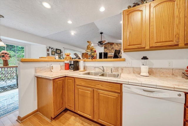 338 White Oak Ln, New Castle, VA 24127 - kitchen featuring white dishwasher, a sink, a ceiling fan, light wood-style floors, and vaulted ceiling
