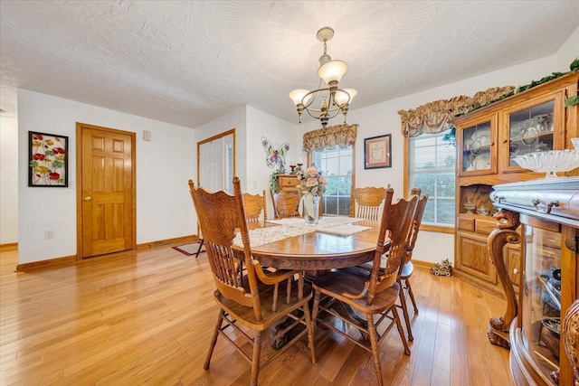 338 White Oak Ln, New Castle, VA 24127 - dining area with a chandelier, baseboards, and light wood-type flooring