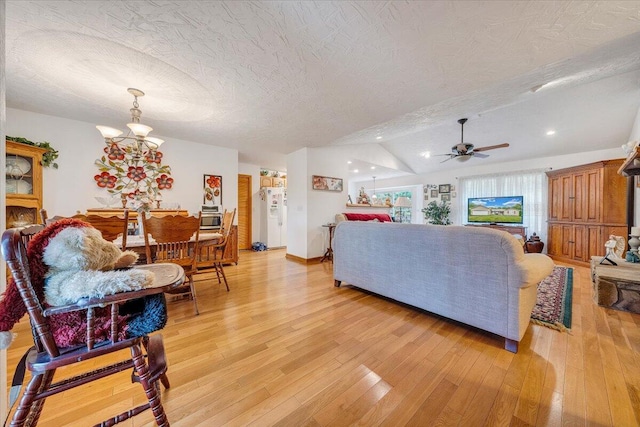 338 White Oak Ln, New Castle, VA 24127 - living room featuring vaulted ceiling, light wood-style floors, a ceiling fan, a chandelier, and a textured ceiling