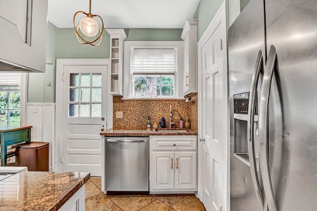 2408 Avenham Ave SW, Roanoke, VA 24014 - kitchen with appliances with stainless steel finishes, a sink, decorative backsplash, white cabinetry, and dark stone countertops