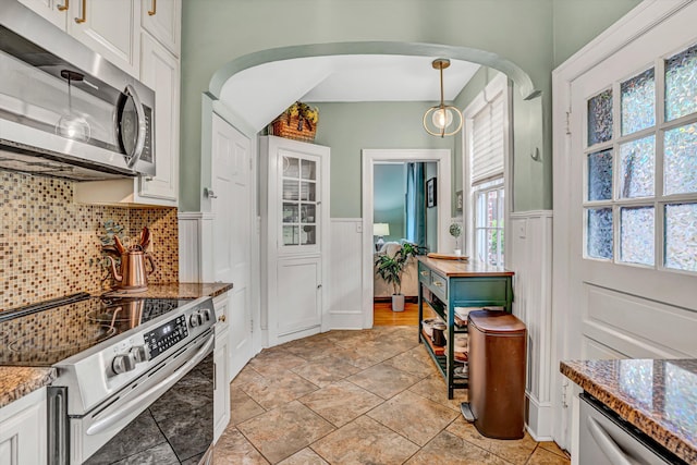 2408 Avenham Ave SW, Roanoke, VA 24014 - kitchen with appliances with stainless steel finishes, arched walkways, white cabinets, tasteful backsplash, and a wainscoted wall