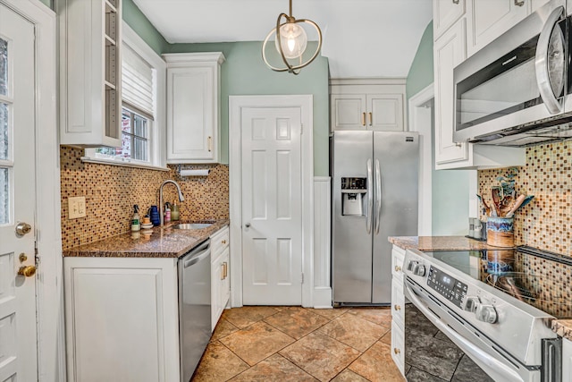 2408 Avenham Ave SW, Roanoke, VA 24014 - kitchen with stainless steel appliances, a sink, decorative backsplash, white cabinetry, and dark stone countertops