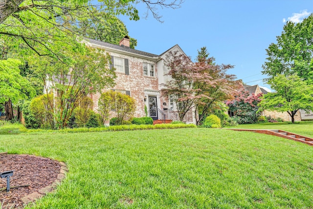 2408 Avenham Ave SW, Roanoke, VA 24014 - colonial-style house with a chimney, brick siding, and a front yard