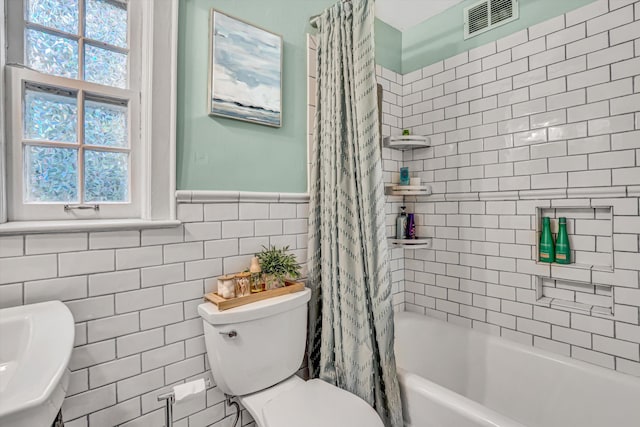 2408 Avenham Ave SW, Roanoke, VA 24014 - full bath with tile walls, toilet, shower / bath combo, and a wainscoted wall