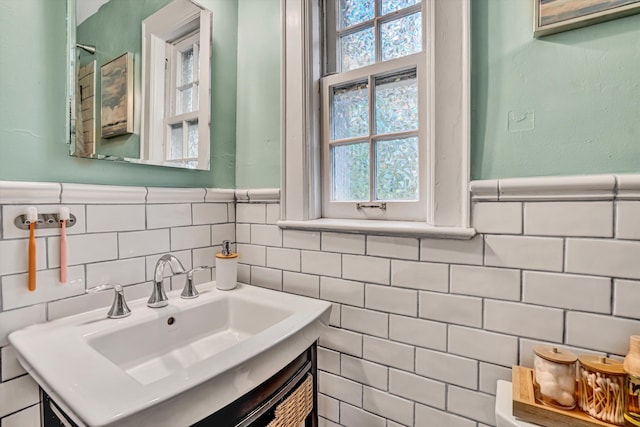 2408 Avenham Ave SW, Roanoke, VA 24014 - bathroom featuring a sink, tile walls, and a wainscoted wall