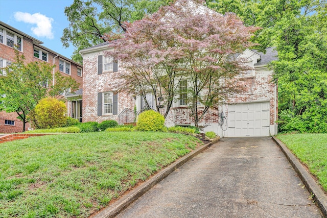 2408 Avenham Ave SW, Roanoke, VA 24014 - view of front of house featuring asphalt driveway, brick siding, an attached garage, and a front lawn